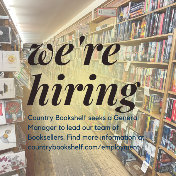 Black text reads "We're Hiring: Country Bookshelf seeks a General Manager to lead our team of Booksellers. Find more information at countrybookshelf.com/employment." The photo shows an aisle with tall bookshelves on one side with various titles and shelf talkers. There is a yellow gradient behind the black text.